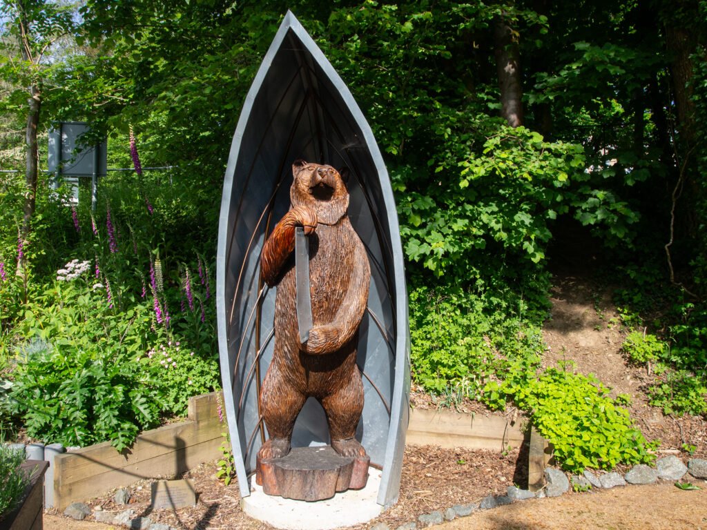 Arthurus The Bear sculpture in a shelter at the Dolwen Field